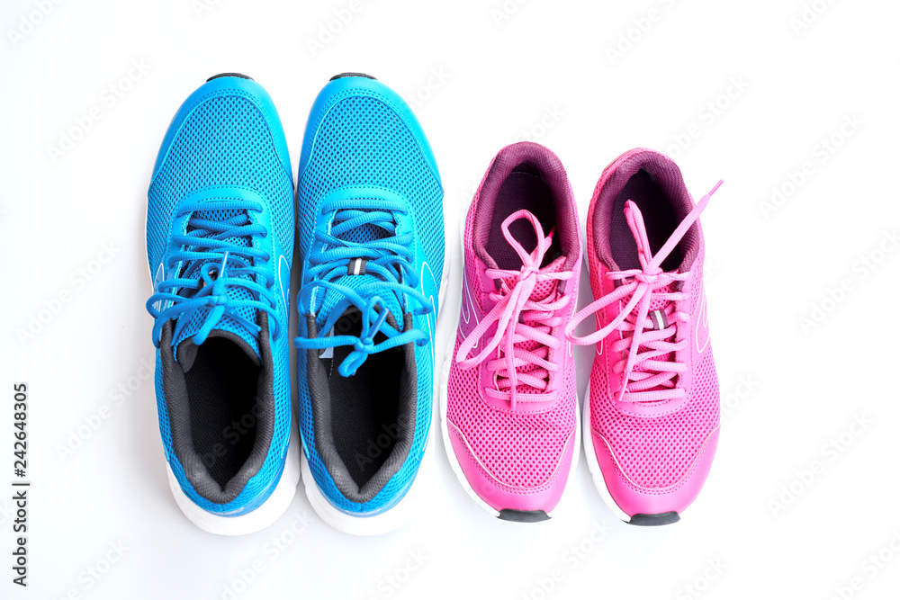 Pair of blue running sneakers for men and pair of pink one for women on white background.