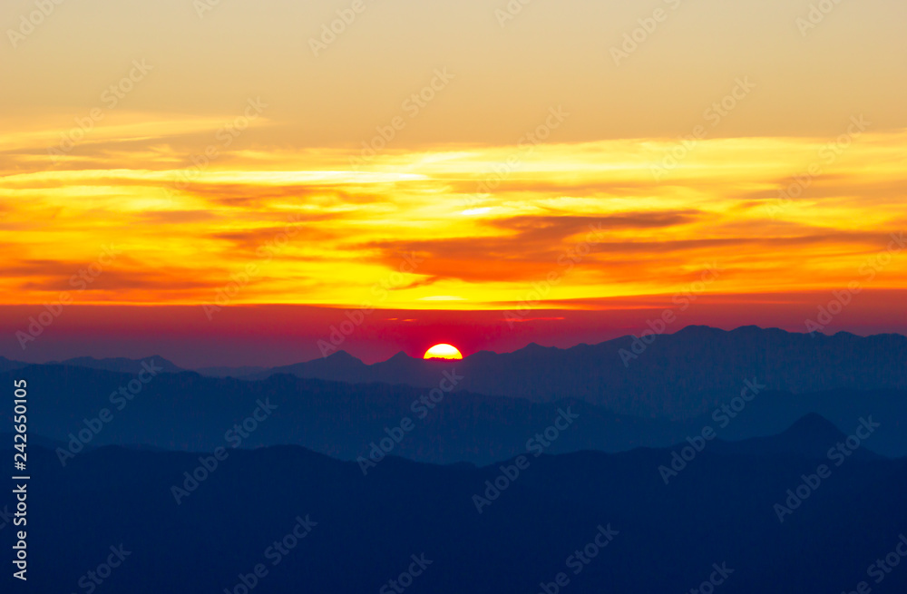 The sun is falling between mountains. Concept of entering the darkness at night or Loneliness and the end of the day.