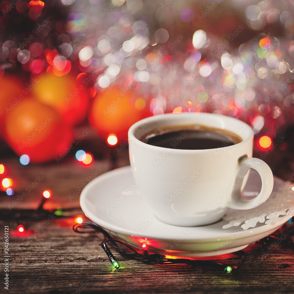 cup of coffee with cinnamon on a Christmas defocused background. cup of coffee with cinnamon on a Christmas defocused background.