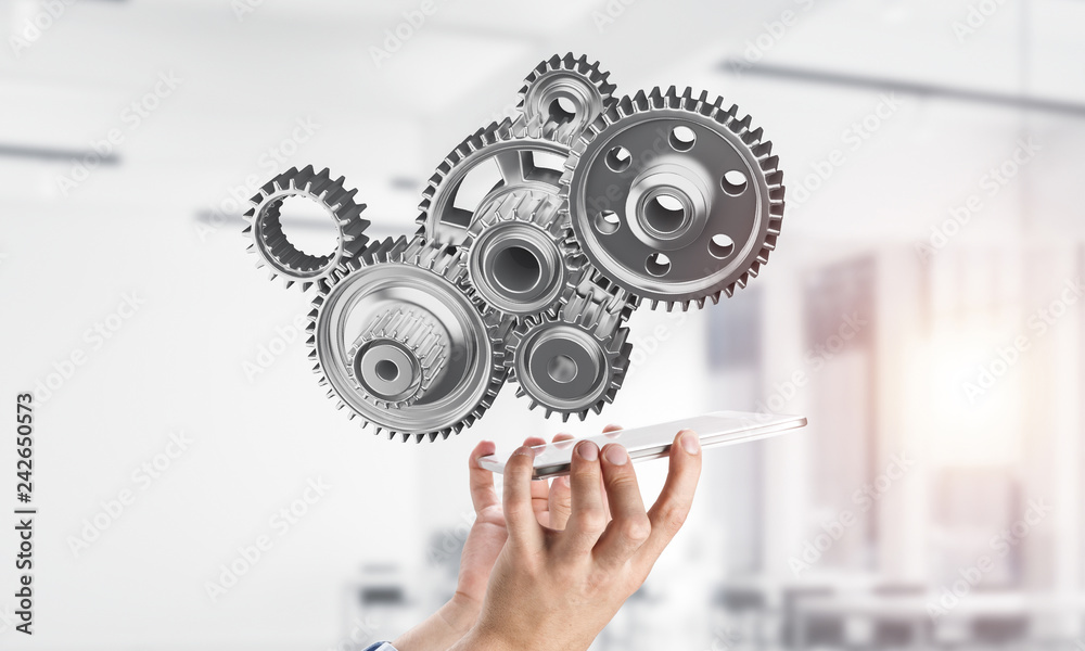 Engine mechanism in male hands as symbol for cooperation or team Engine mechanism in male hands as symbol for cooperation or team