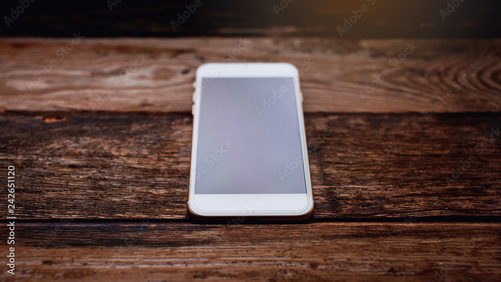 White phone with screen on the wooden background White phone with screen on the wooden background