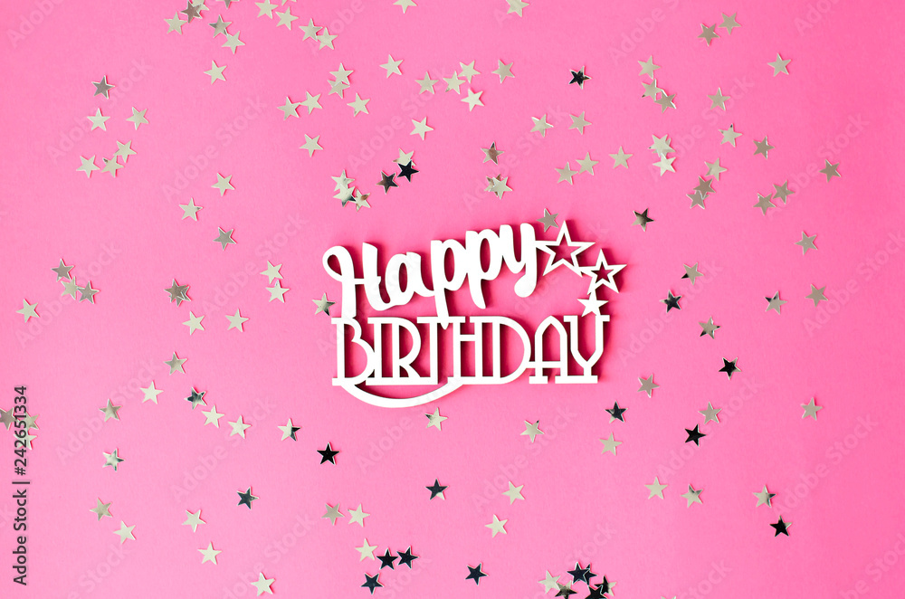 Wooden inscription happy birthday on a pink background.