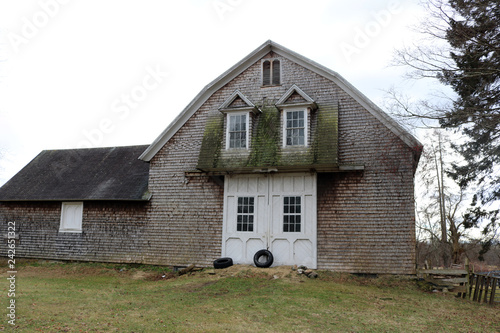 Old weathered rustic wooden barn on historic New England farm
