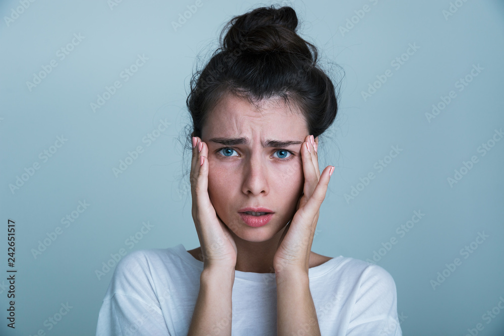 Close up of a shocked young woman wearing shirt Close up of a shocked young woman wearing shirt