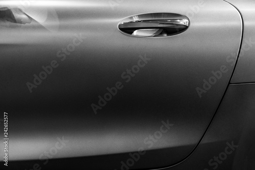 Black and white car door with handle