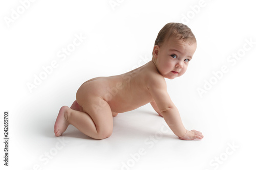 Naked baby sitting on the floor