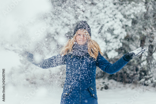 Bild auf Leinwand Young attractive beautiful pretty winter woman playing with snow in forest - mad