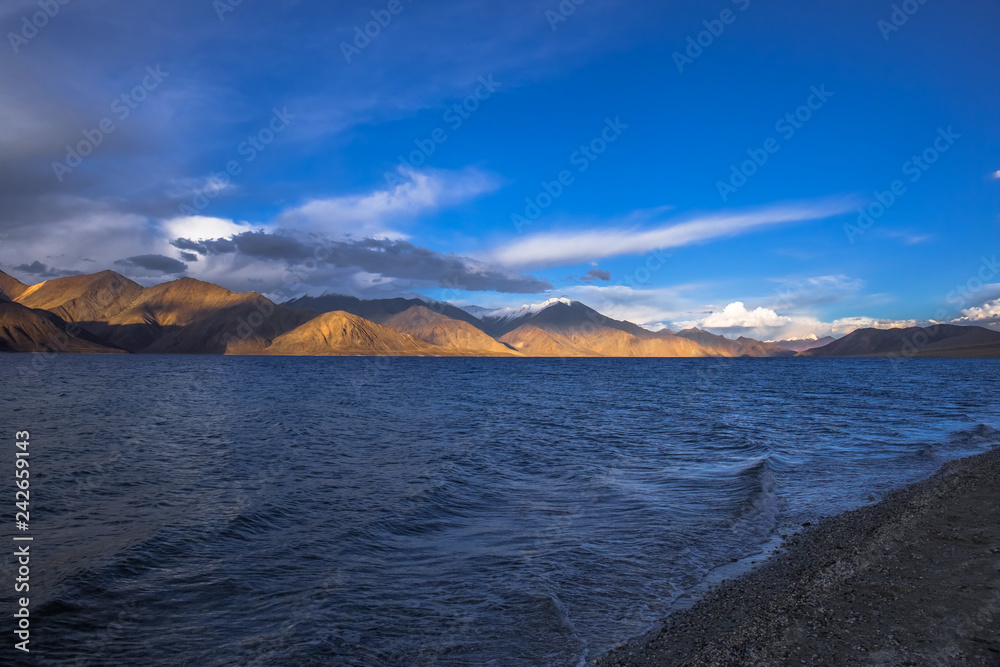 View of Lake Pangong with beautiful mountains in blue sky and reflection. Leh Ladakh, India