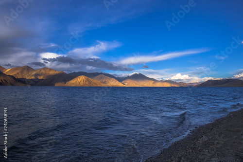 View of Lake Pangong with beautiful mountains in blue sky and reflection. Leh Ladakh, India