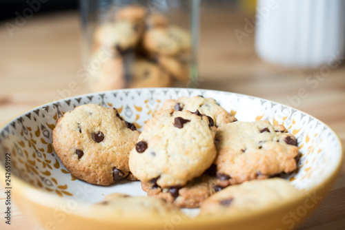 Homemade cookies on a plate with jar