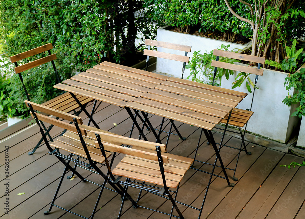 wooden chairs and wooden tables at the cozy outdoor terrace wooden chairs and wooden tables at the cozy outdoor terrace