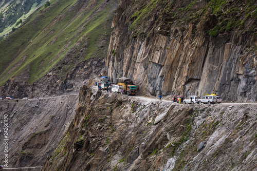 Trucks carrying goods are passing through Zojila Pass, India.
