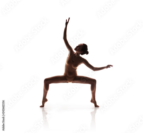 young beautiful dancer in beige swimsuit posing © Aleksandr Doodko