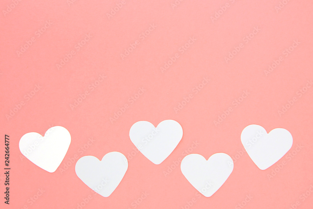 White paper hearts on pink background with copy space