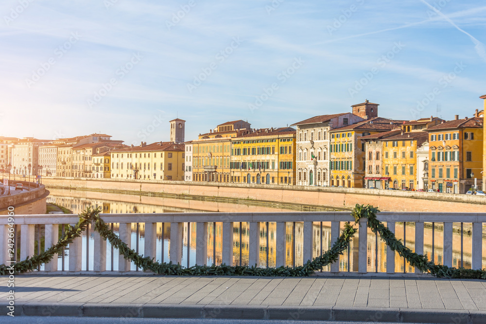 Obraz premium View on embankment and bridge of Arno river Pisa, Italy.