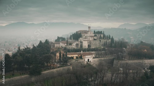 Aerial shot of Castle of Brescia on a foggy day, Italy photo