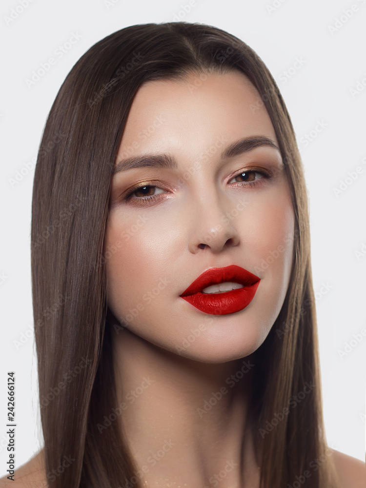 Close-up portrait of sexy european young woman model with classic glamour make-up and red lipstick. Dark long hairstyle, christmas makeup, dark eyeshadows, bloody red lips with gloss