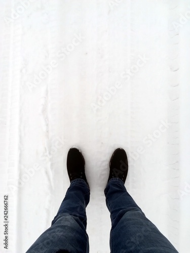 feet of a guy standing in the snow