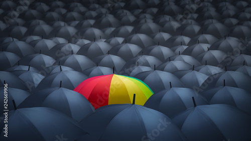 businessman with colorful rainbow umbrella among others, unique different concept