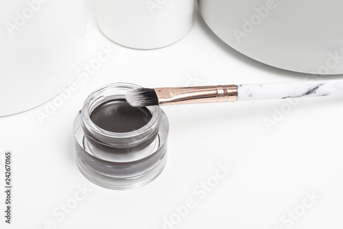 Brown gel for eyebrows on toilet table photo