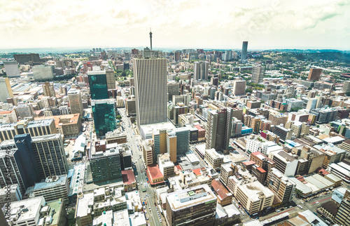 Aerial view of skyscrapers cityscape in business district of Johannesburg - Architecture concept with modern building skyline in South Africa big city - Landscape on desaturated dramatic filtered look