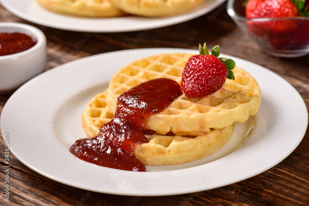 Waffles and jam on breakfast table Waffles and jam on breakfast table