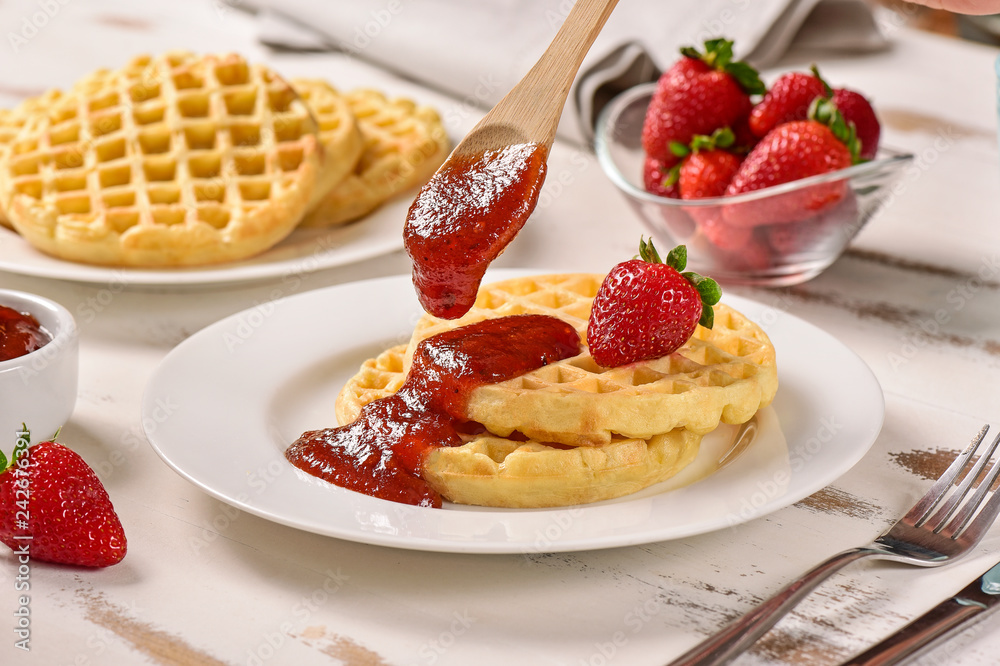Waffles and jam on breakfast table Waffles and jam on breakfast table
