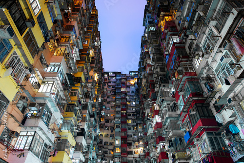 Hong Kong density residential famous travel place Yick Fat building at night. photo