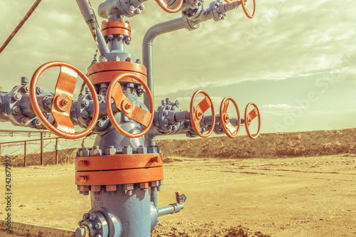 Wellheads with valve armature on a oil field. photo