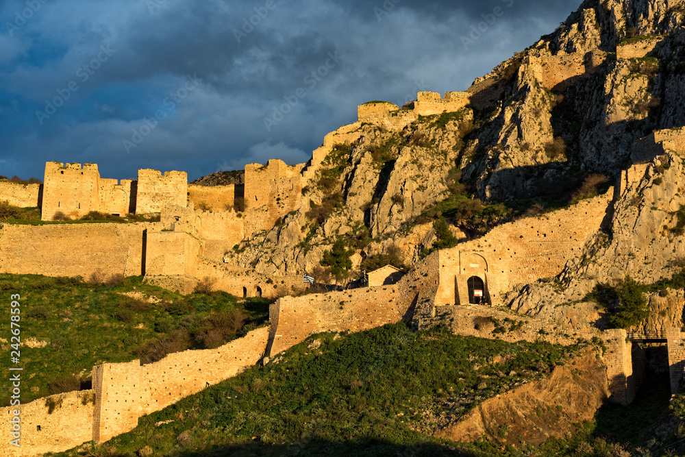 View of the archaeological site of Acrocorinth, the acropolis of ancient Corinth in Peloponnese, Greece at sunset