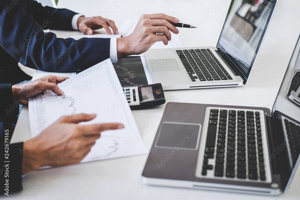 Business team investment working with computer and analysis graph stock market trading with stock chart data, business and technology concept Business team investment working with computer and analysis graph stock market trading with stock chart data, business and technology concept