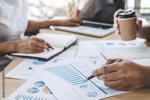 Business team colleagues discussing working analysis with financial data and marketing growth report graph in team, Meeting Talking Brainstorming Communication Concept