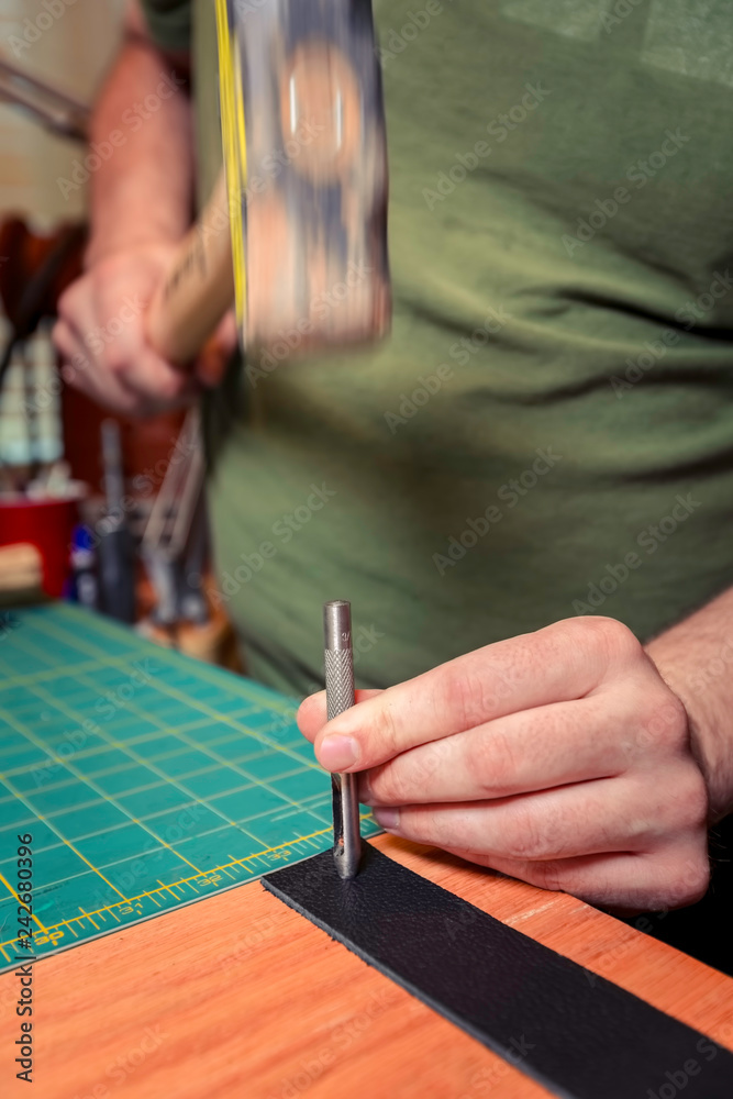Motion Shot Punching a Hole for a Rivet Into Leather Motion Shot Punching a Hole for a Rivet Into Leather