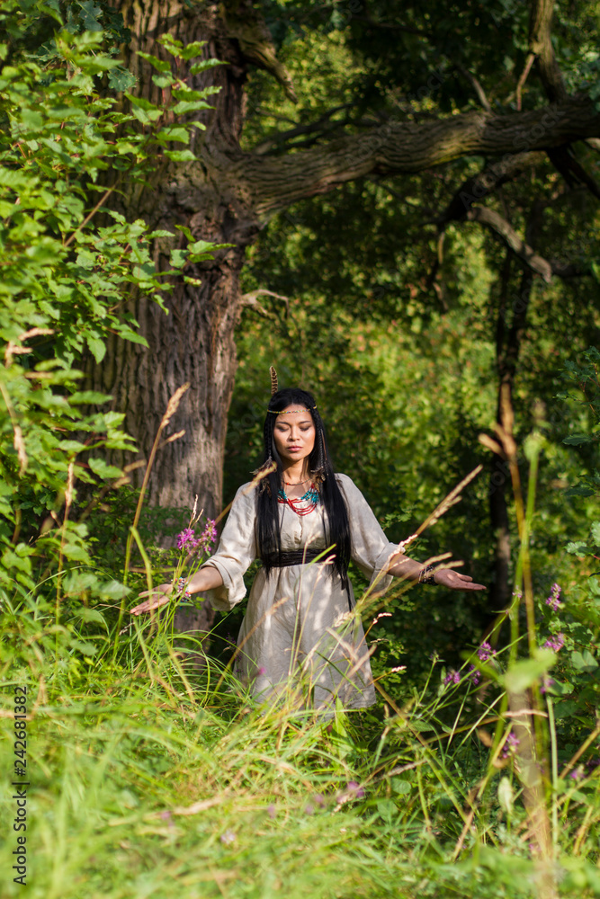 woman shaman conjures in the forest woman shaman conjures in the forest