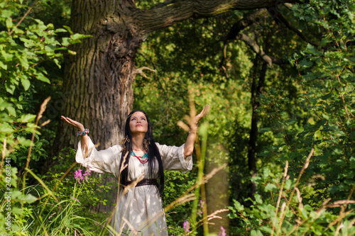 woman shaman conjures in the forest