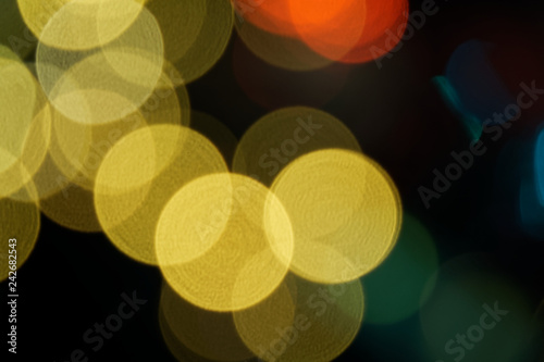 Defocused abstract round circles background with garland lights bokeh in the dark.