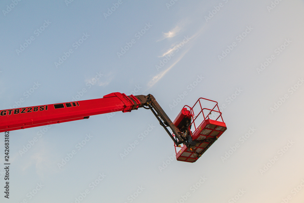 Red bucket crane mounted on truck.Truck mounted Articulating boom lift