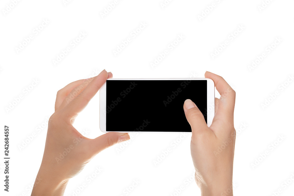 Mock-up of modern smartphone in the hands of a girl. Phone in horizontal position with a blank screen and isolated on white Mock-up of modern smartphone in the hands of a girl. Phone in horizontal position with a blank screen and isolated on white