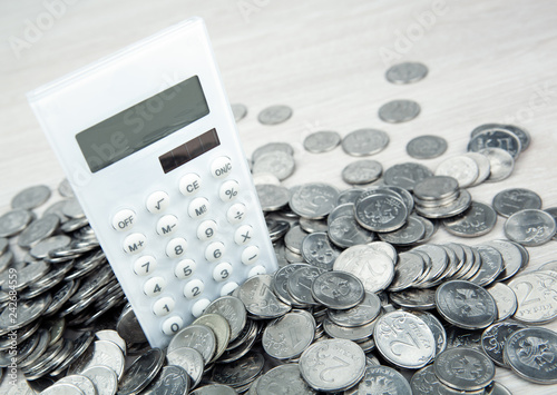 white calculator with russian ruble coins close up