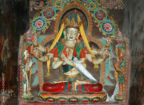 Fotografi White Tibetan deity statue with six arms in a monastery in Tibet