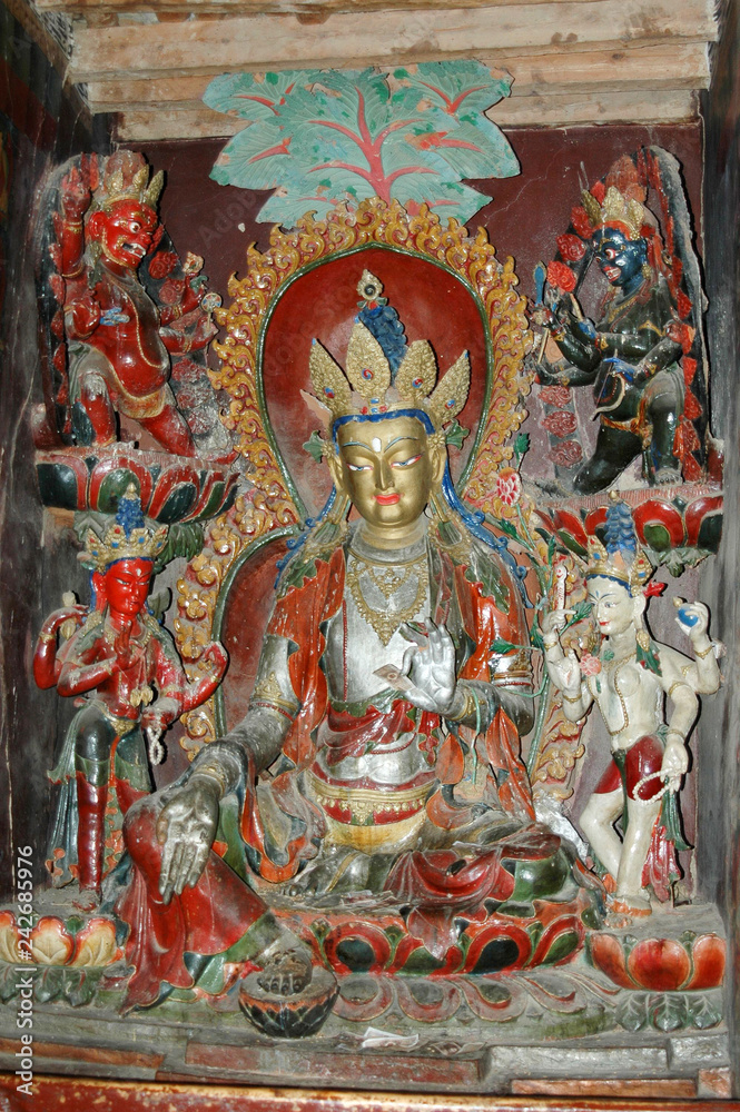 Ancient sacred statue of a deity with a silvery body in a Tibetan monastery Ancient sacred statue of a deity with a silvery body in a Tibetan monastery
