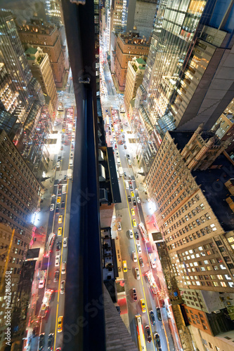 Manhattan, New York City. Night aerial view of city traffic from a high viewpoint with skyscrapers glass reflections