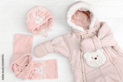 Autumn or winter fashion outfit. Baby girl pink set of clothing on the white background.