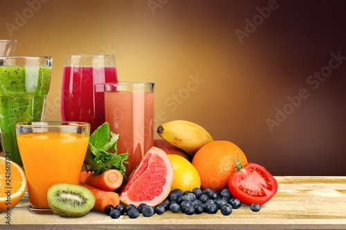 Fresh ripe healthy fruits and juices in glasses