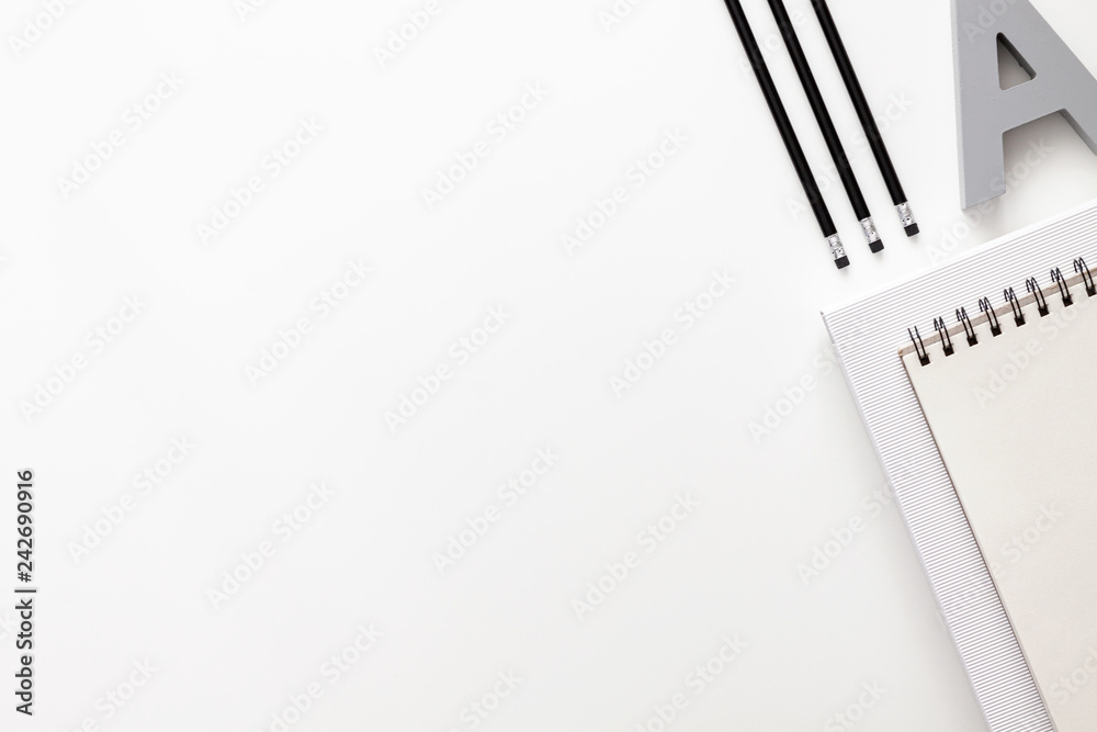 White office desk with empty space for text. Copy space. Office accessories such as pencils and notebook. View from the top White office desk with empty space for text. Copy space. Office accessories such as pencils and notebook. View from the top