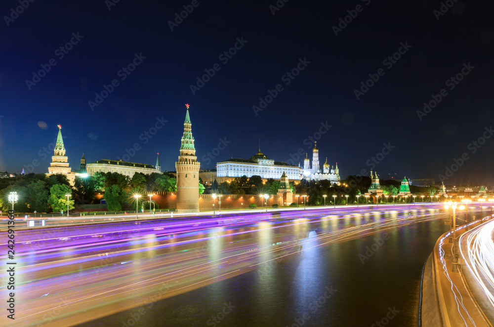 Moscow Kremlin, Kremlin Embankment and Moscow River at night against a dramatic sky in Moscow, Russia. Architecture and landmark of Moscow
