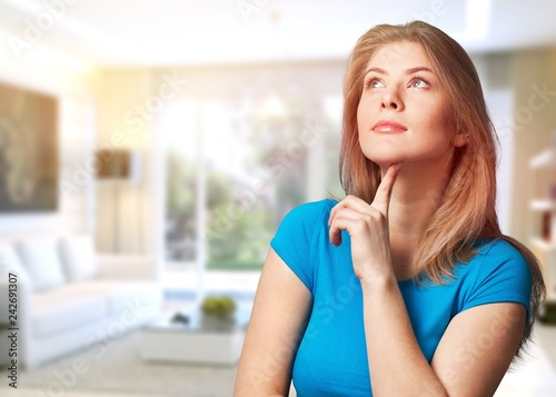 Pretty young thoughtful woman on blurred blue background Free Download Pretty young thoughtful woman on blurred blue background - GFXLoad