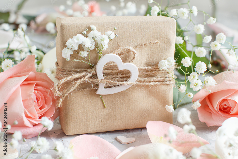 Gift box with roses and small white flowers Gift box with roses and small white flowers