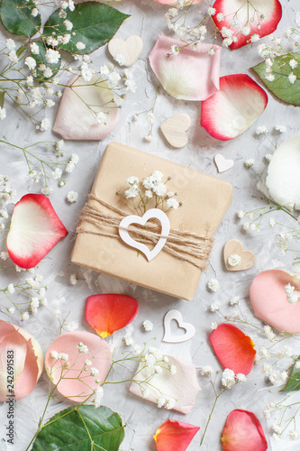 Gift box with roses and small white flowers