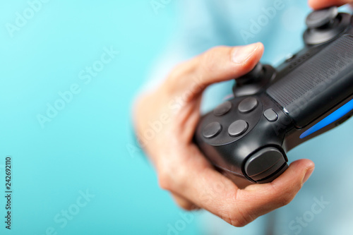 Male hands holding a gaming controller
